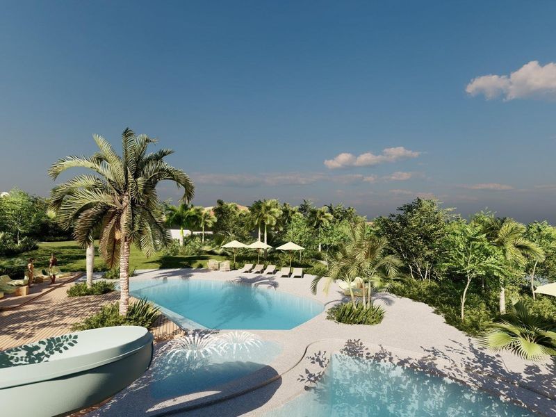 A beautifully landscaped outdoor pool area featuring a swimming pool, wooden decking, and lush tropical garden surroundings.