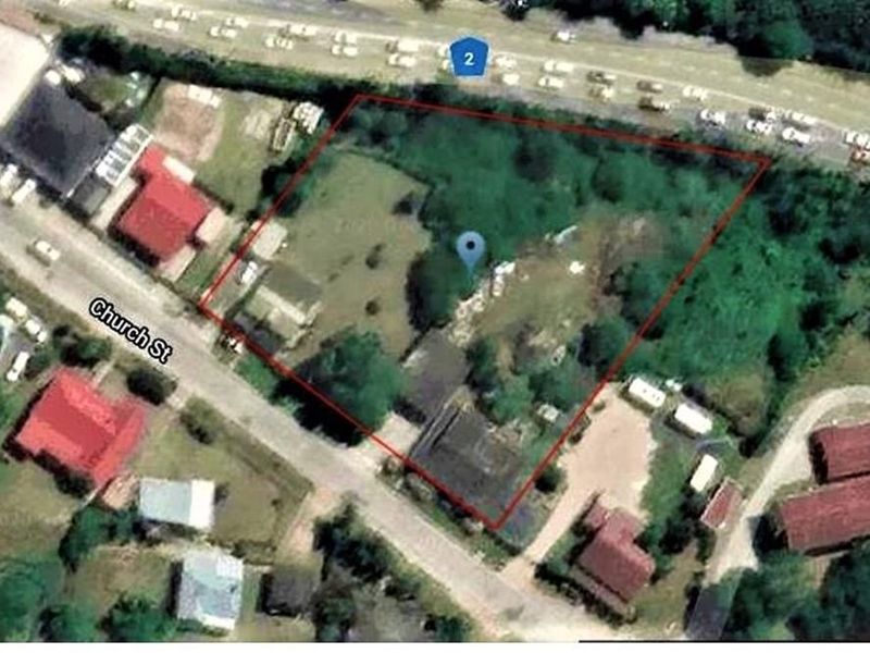An aerial view showing the property boundary and surrounding street layout, including proximity to Church Street and main road access.