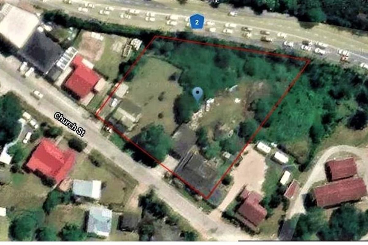 An aerial view showing the property boundary and surrounding street layout, including proximity to Church Street and main road access.