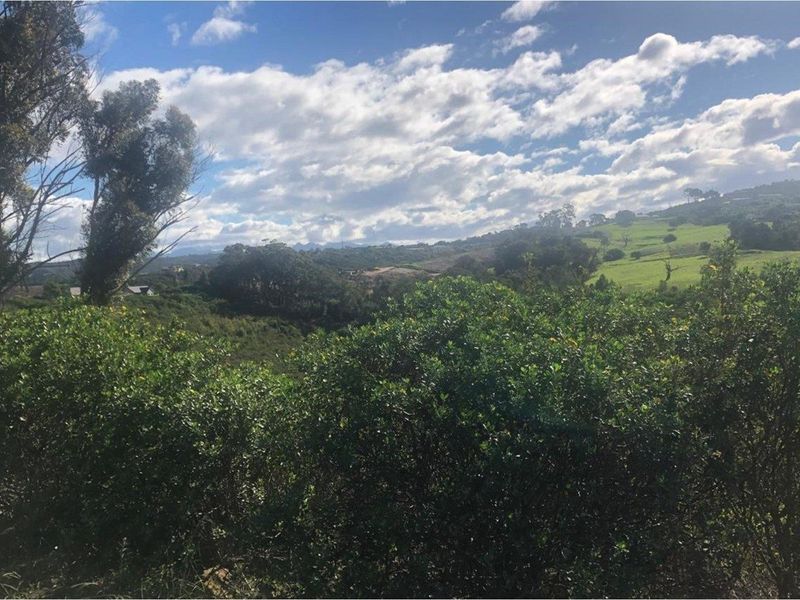 A scenic view of the surrounding natural landscape and rolling hills, showcasing the property's tranquil and elevated position.