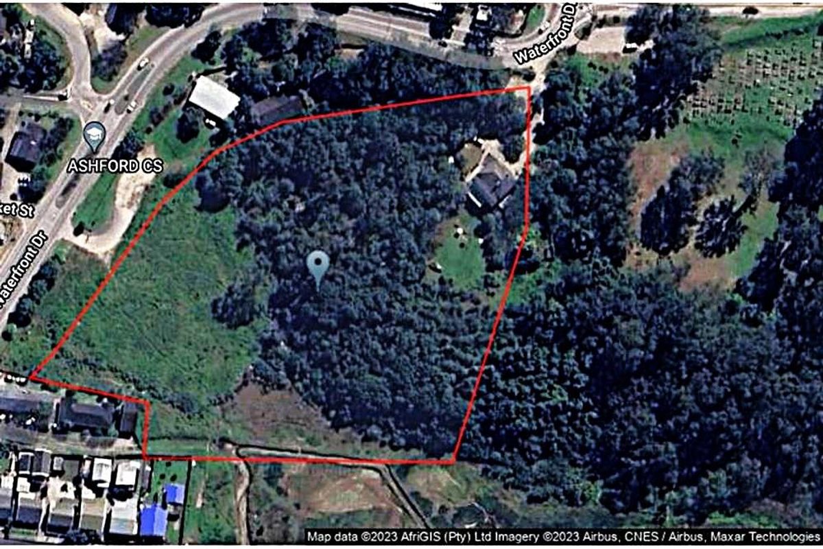 An aerial view showing the property boundary and surrounding landscape, including access roads and dense vegetation.