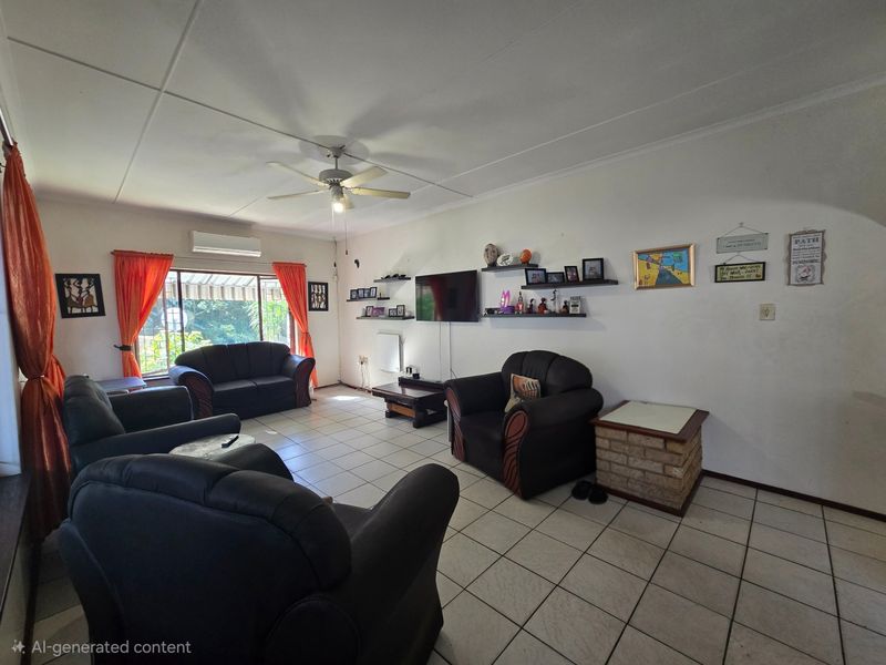 A spacious living room featuring tiled flooring, a ceiling fan, and a split-system air conditioner, with direct access to an outdoor area via sliding doors.