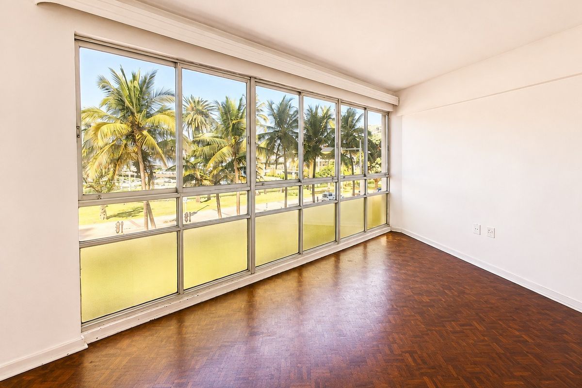 Bright and spacious living area featuring classic parquet flooring and expansive windows offering pleasant views of palm trees and the surrounding area.