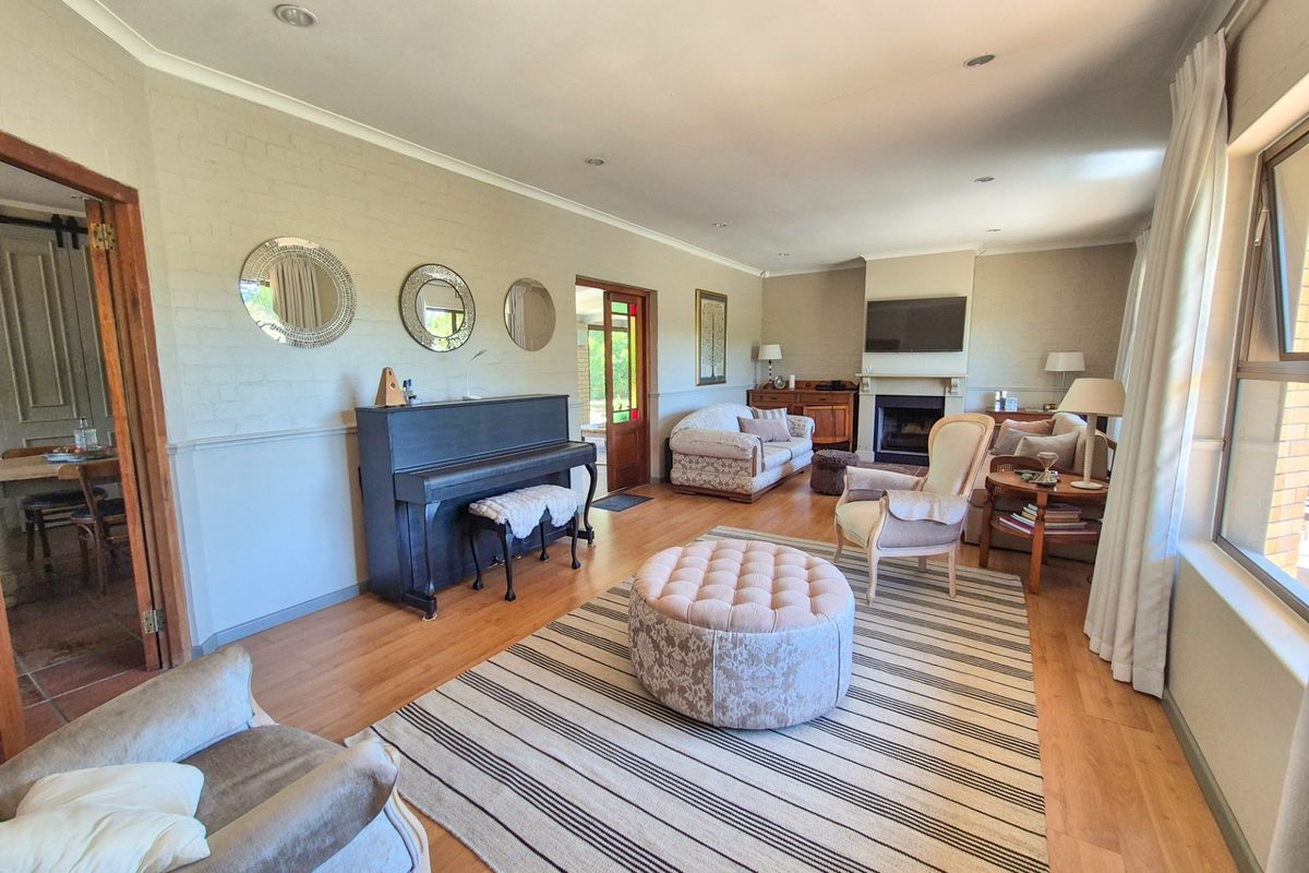 Spacious living room featuring laminate flooring, a central fireplace, and recessed lighting, offering a comfortable and well-maintained living space.