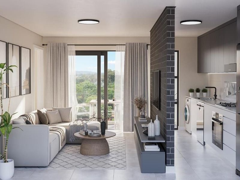 Modern open-plan living area featuring a sleek kitchen with built-in appliances, a brick feature wall, and sliding doors leading to a balcony.
