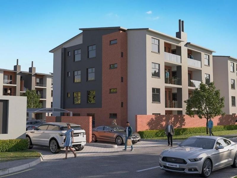A modern apartment complex exterior featuring brick and rendered facades, private balconies, and a gated entrance with signage.