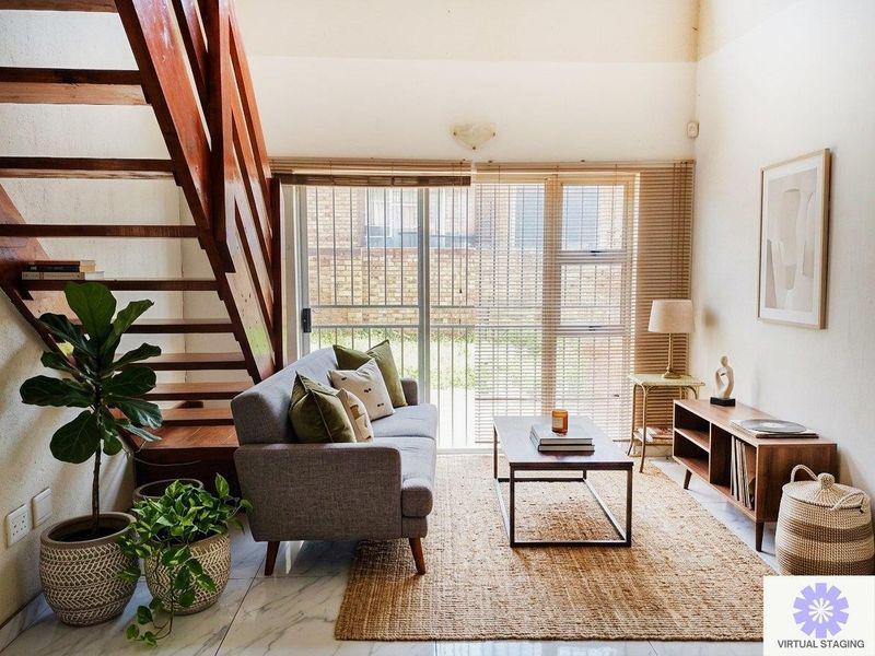 A living room featuring a wooden staircase, tiled flooring, and a sliding glass door leading to the exterior.