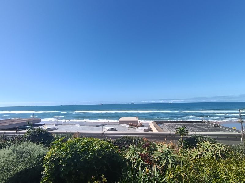 A clear, elevated view of the ocean and coastline, showcasing the expansive horizon and coastal landscape.