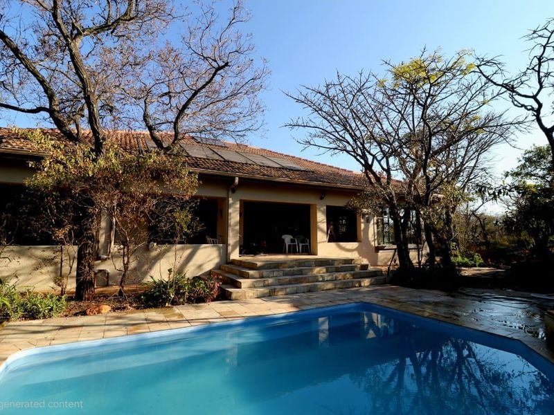 Rear exterior view featuring a swimming pool, paved patio area, and stone steps leading to the main house with solar panels on the roof.