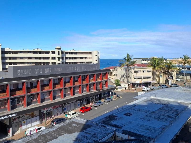 Elevated urban view overlooking the surrounding neighbourhood, street level, and coastal horizon.