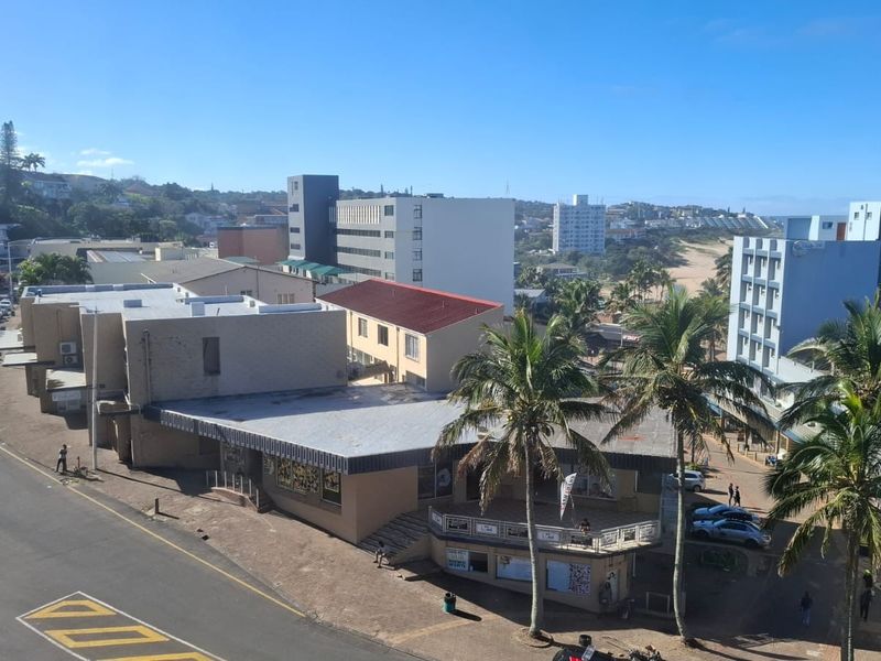 Elevated urban view overlooking the surrounding neighborhood, street infrastructure, and coastal landscape.