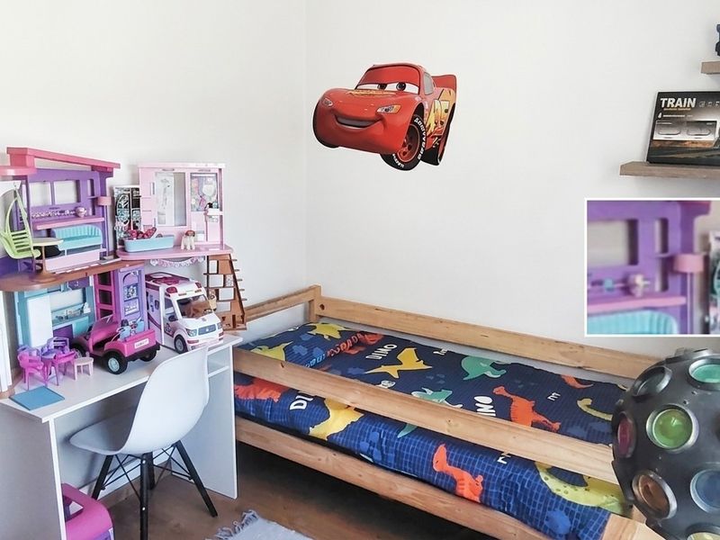 A child's bedroom featuring neutral walls and floating shelving units.