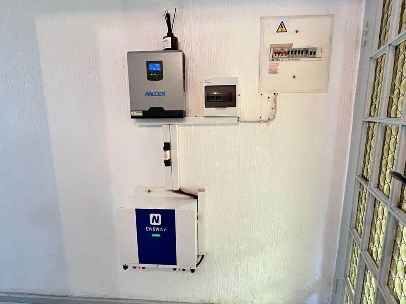 Utility wall featuring a Mecer inverter and N-Energy lithium battery system, integrated with the property's electrical distribution board.