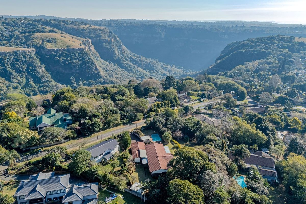 Aerial view of the property showcasing the residential setting, surrounding landscape, and proximity to the scenic valley.