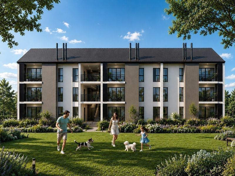 A modern apartment building exterior featuring private balconies, large glass doors, and a well-maintained landscaped garden area.