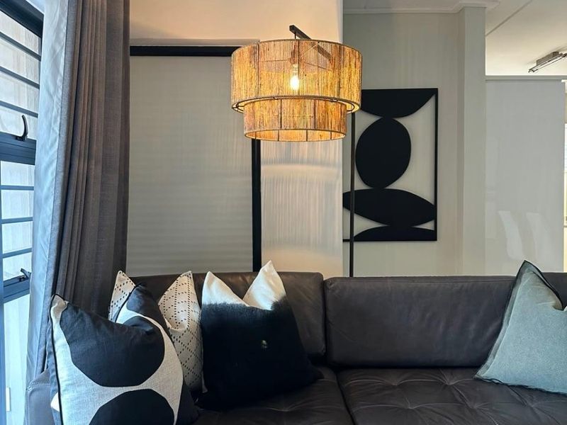 A well-maintained living room area featuring modern aluminium window frames and neutral wall finishes, creating a comfortable and inviting atmosphere.