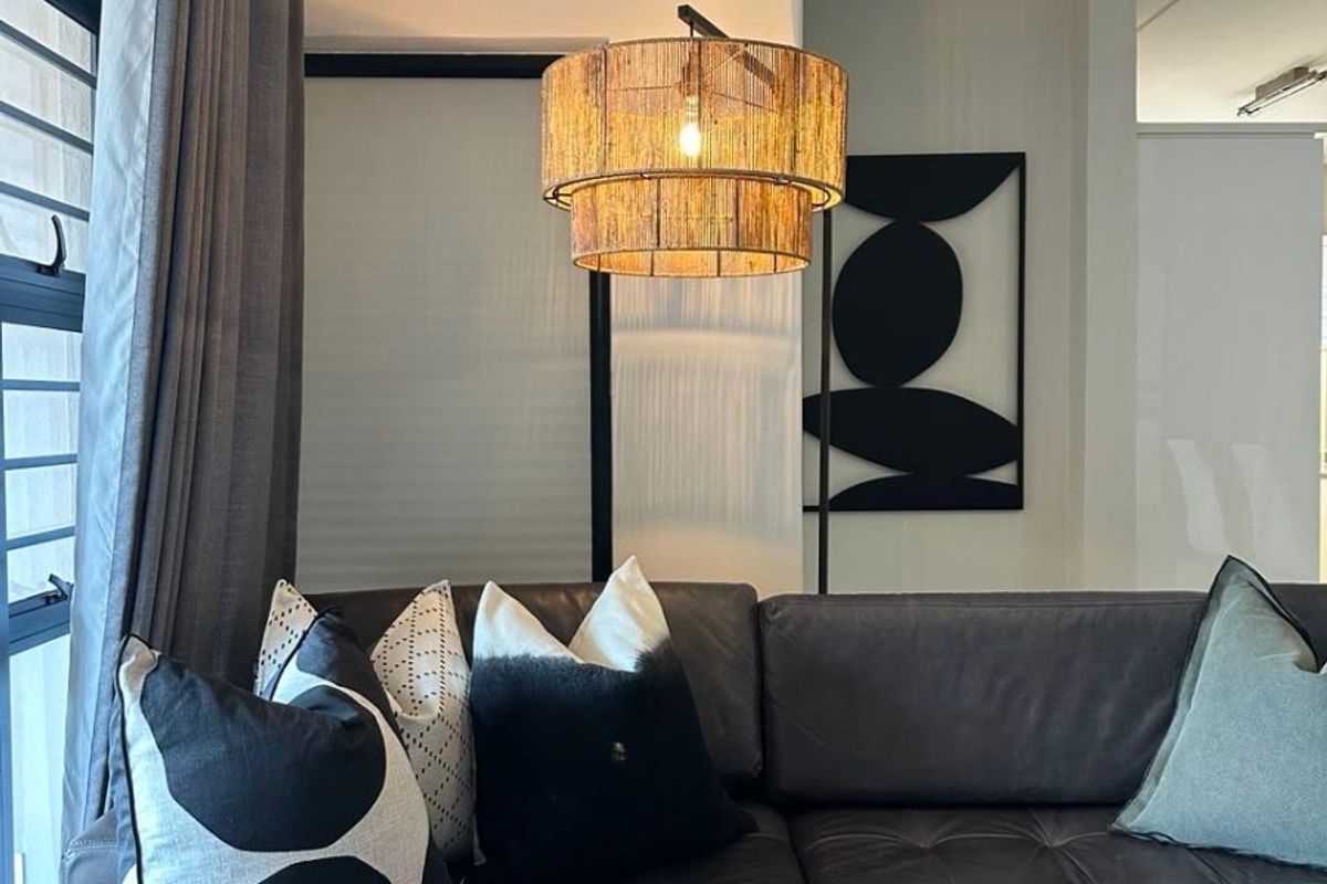 A well-maintained living room area featuring modern aluminium window frames and neutral wall finishes, creating a comfortable and inviting atmosphere.