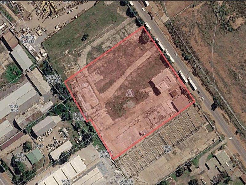 Aerial view of a commercial industrial plot with existing building foundations and site access.