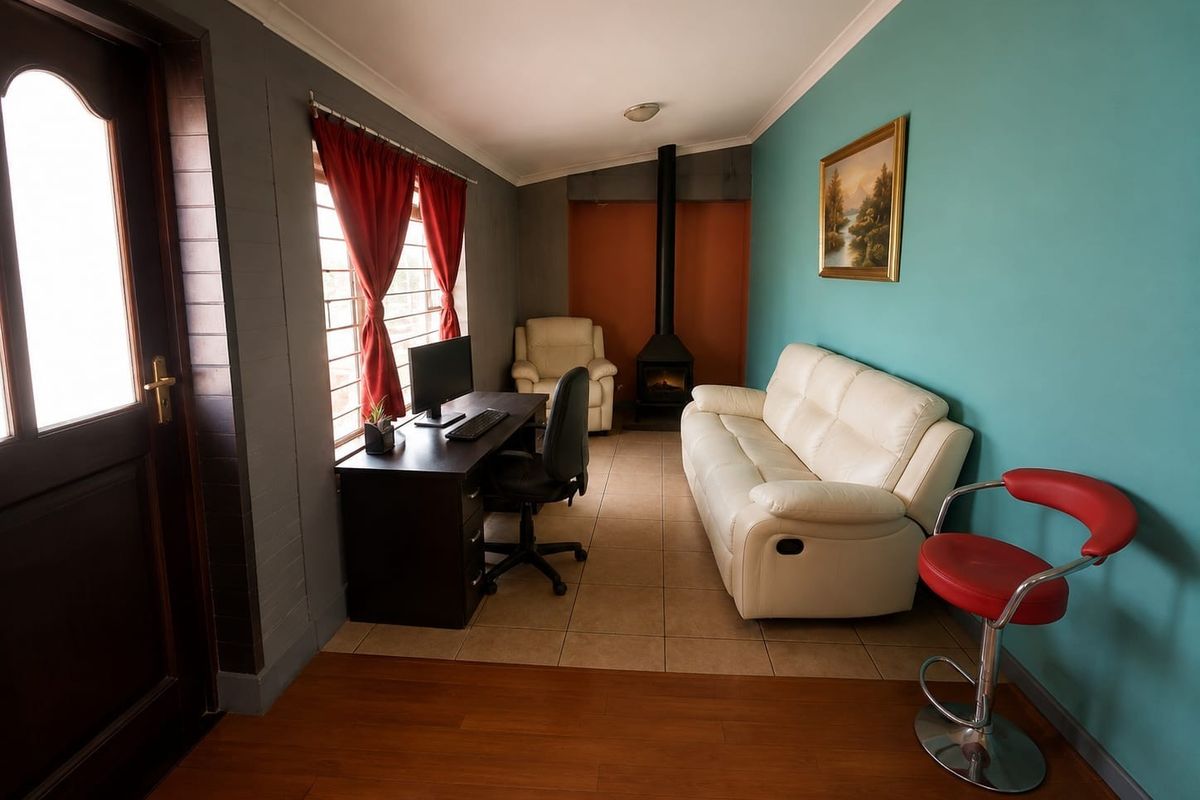A multi-functional living space featuring a freestanding fireplace, tiled and laminate flooring, and large windows with security bars.