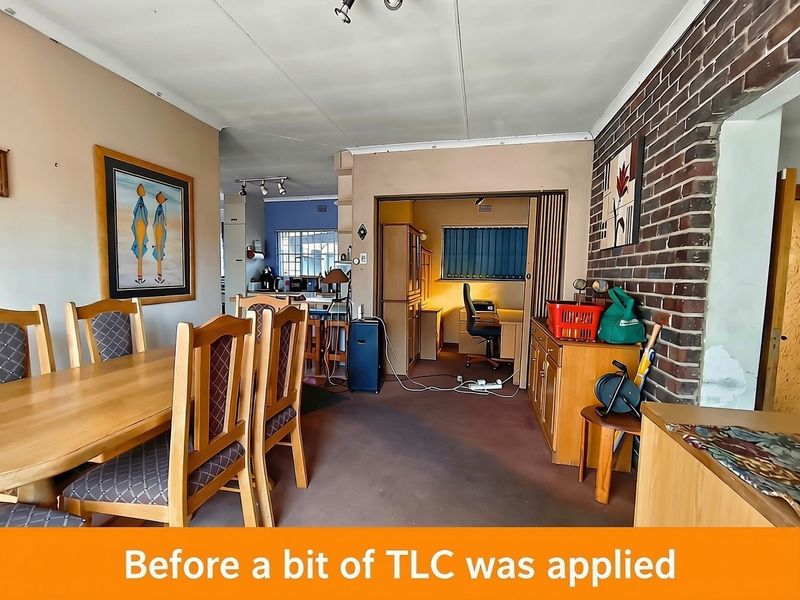 Open plan living and dining area featuring an exposed brick feature wall and a sliding partition leading to an adjacent office space.