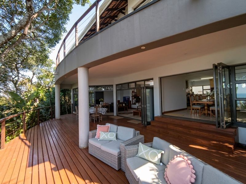 Spacious covered timber deck featuring bi-fold doors that provide seamless indoor-outdoor flow to the main living areas.