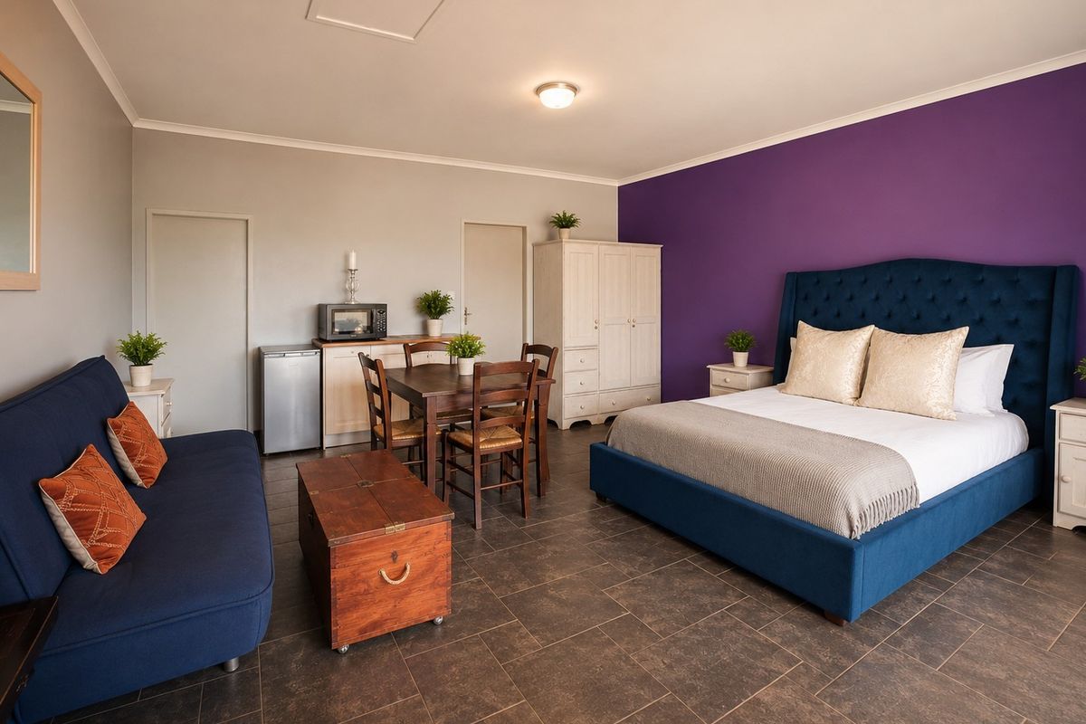 Spacious bedroom featuring tiled flooring, a built-in cupboard, and a loft access hatch, offering a versatile layout with integrated living and dining space.