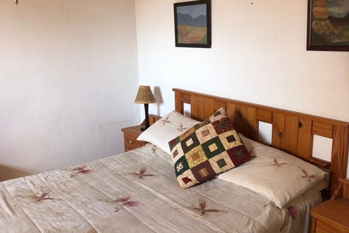 A standard bedroom featuring neutral wall finishes and a functional layout, suitable for modernization or cosmetic updates.