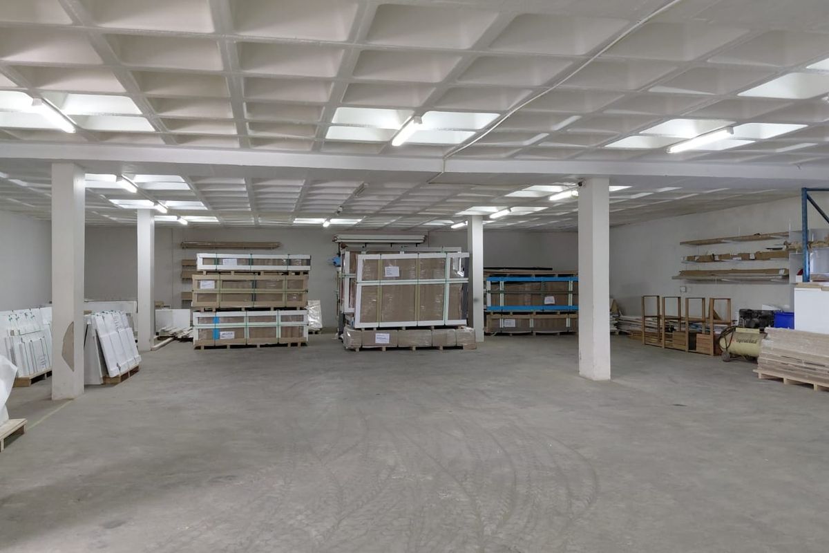 Spacious industrial utility or warehouse area featuring a waffle slab ceiling, concrete flooring, and structural support columns, suitable for storage or light industrial operations.