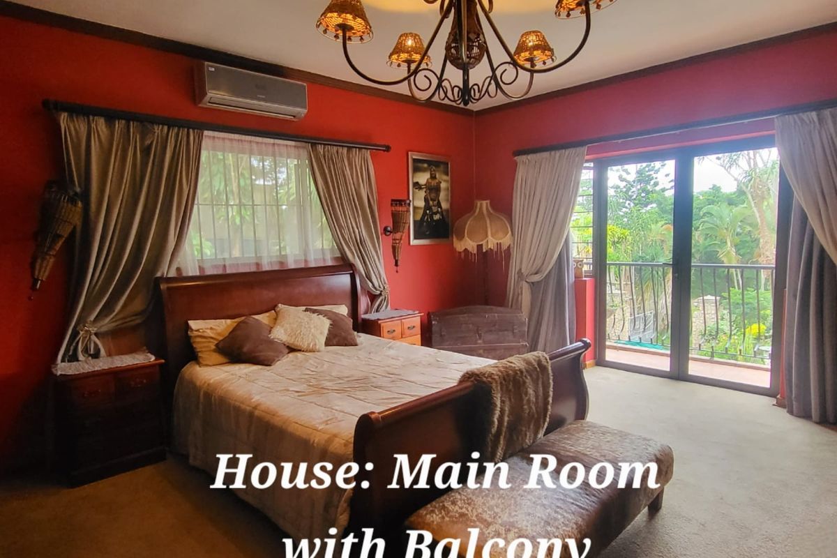Spacious bedroom featuring a split-system air conditioner, decorative chandelier, and direct access to a private balcony through sliding glass doors.
