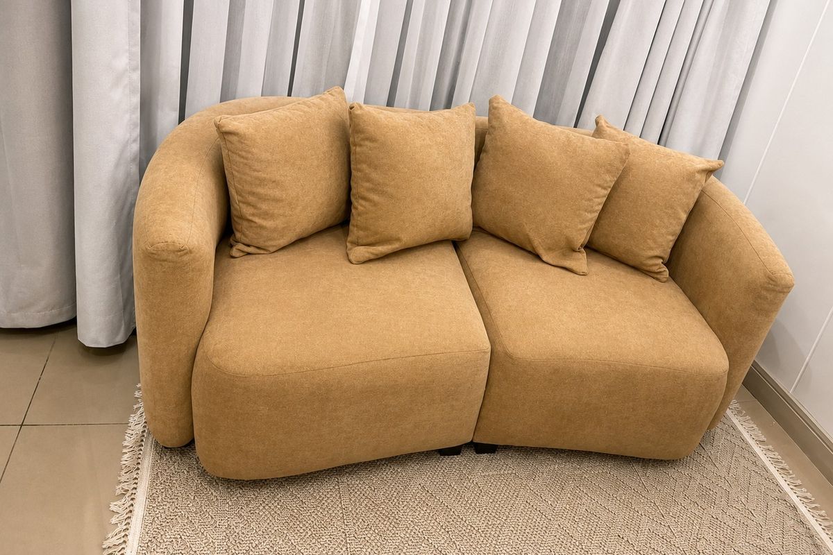 A cozy living area featuring neutral curtains and tiled flooring, providing a comfortable and well-maintained space.