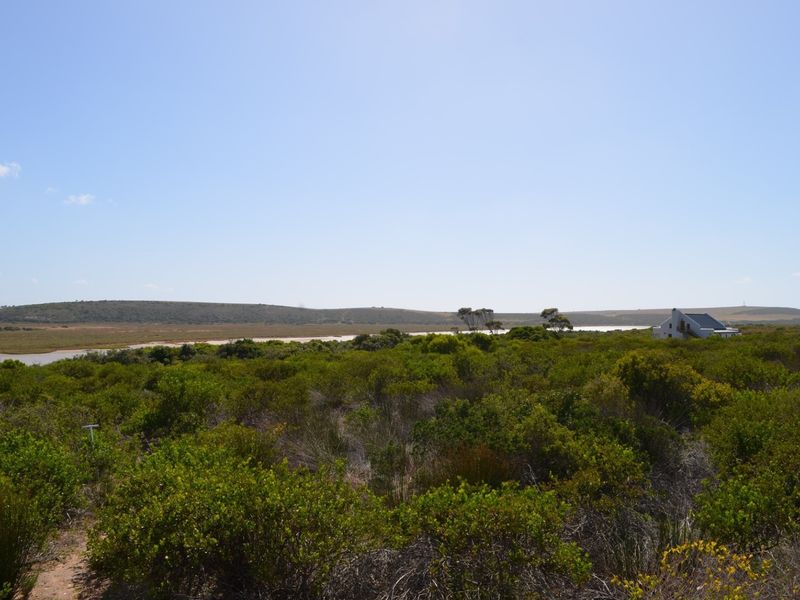 A scenic view of the natural coastal landscape and surrounding vegetation, showcasing the open environment of the residential land.