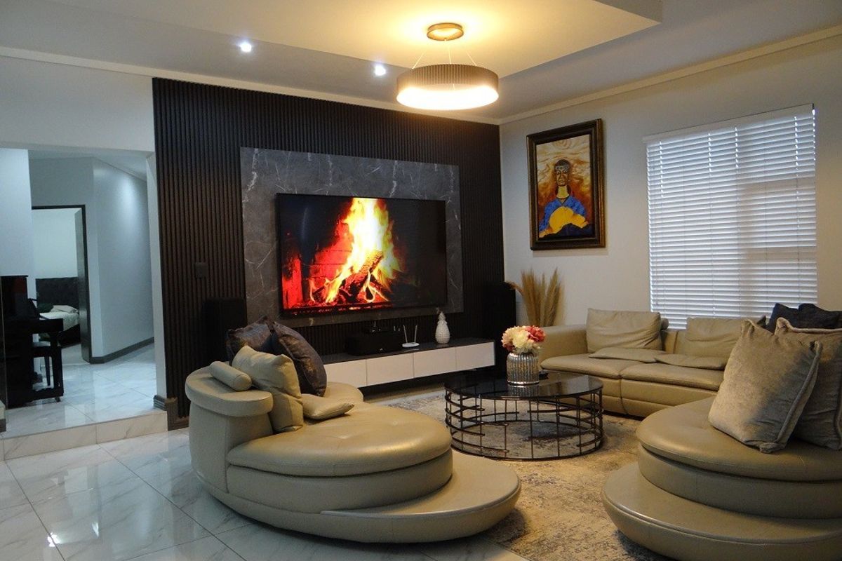 Modern living room featuring a striking slatted wood and marble feature wall, recessed ceiling lighting, and polished tiled flooring.