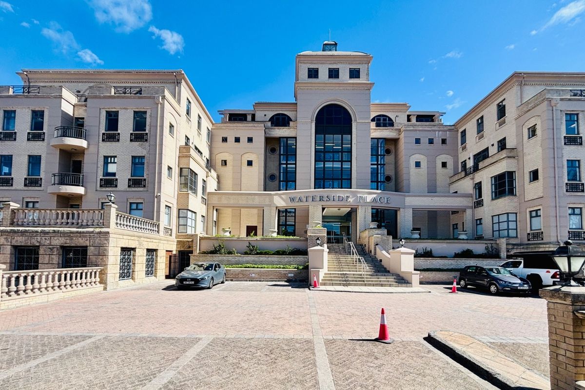 Front elevation of Waterside Place, a multi-story office building featuring a paved driveway, stone balustrades, and a prominent central entrance.