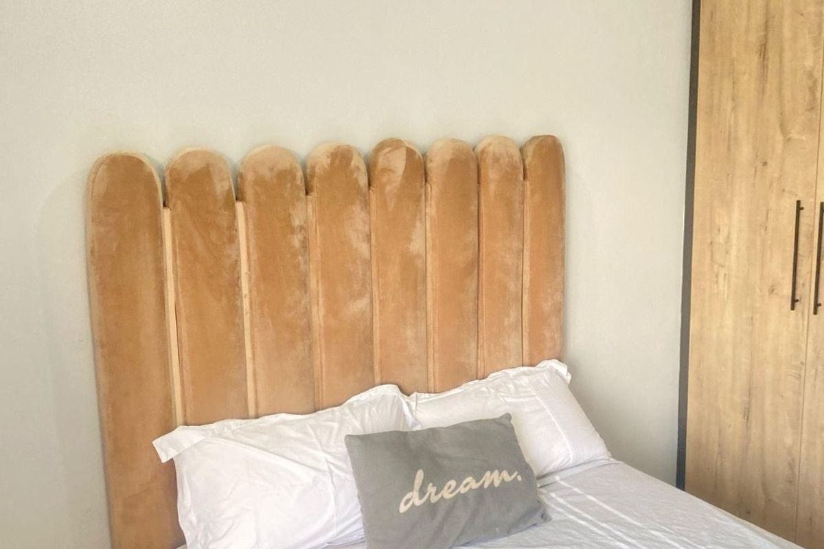A well-maintained bedroom featuring a built-in wardrobe and decorative coving, providing a clean and functional living space.