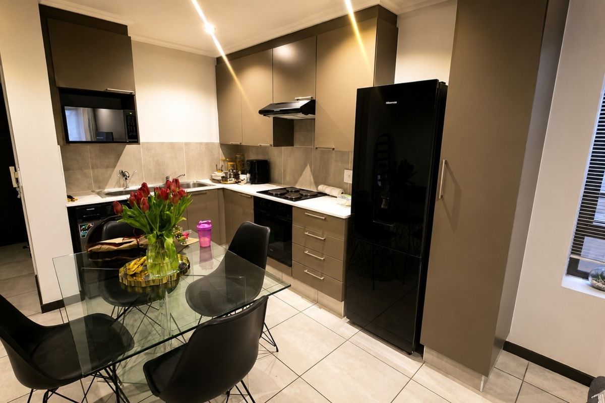 Modern kitchen featuring sleek cabinetry, integrated appliances, tiled flooring, and a functional layout with ample storage and workspace.