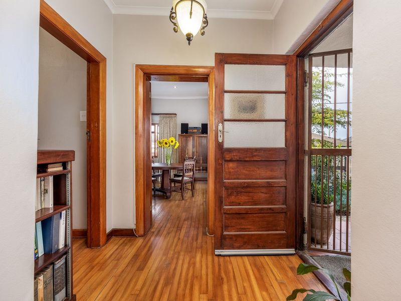 Welcoming entrance hall featuring polished timber flooring, classic timber door frames, and a secure front door leading into the main living area.