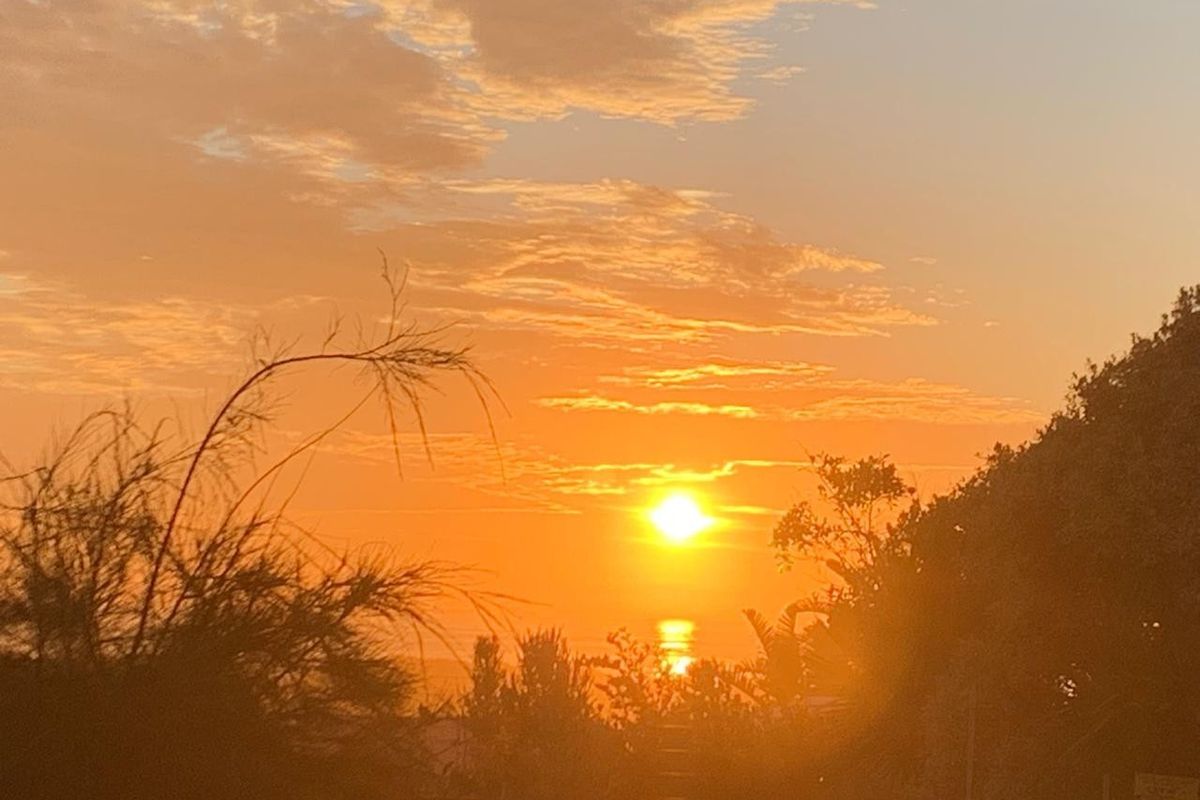 A scenic sunset view over the horizon, showcasing the natural landscape and atmosphere of the property location.