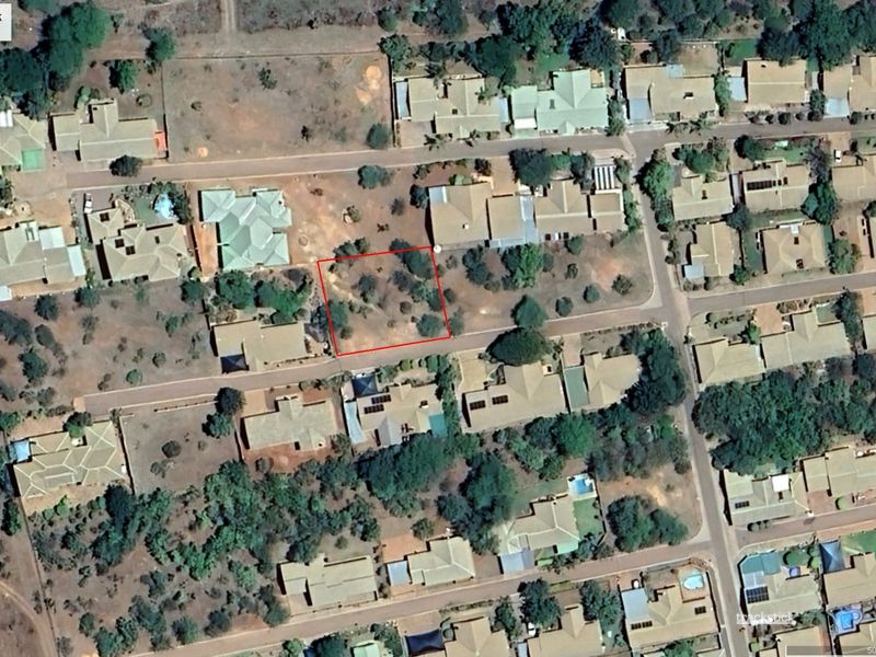 Aerial view of a vacant residential stand located within a developed suburban neighborhood.