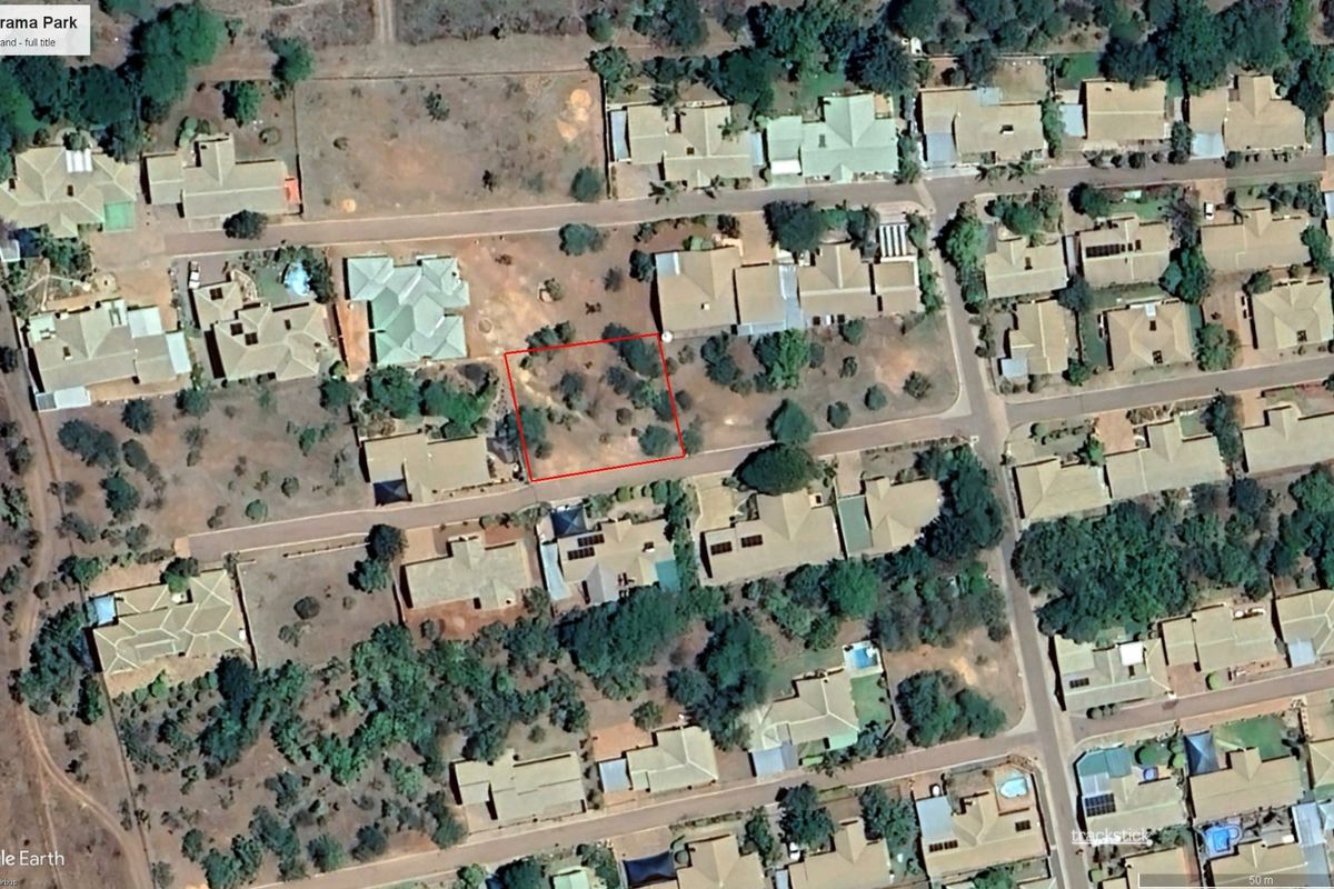 Aerial view of a vacant residential stand located within a developed suburban neighborhood.