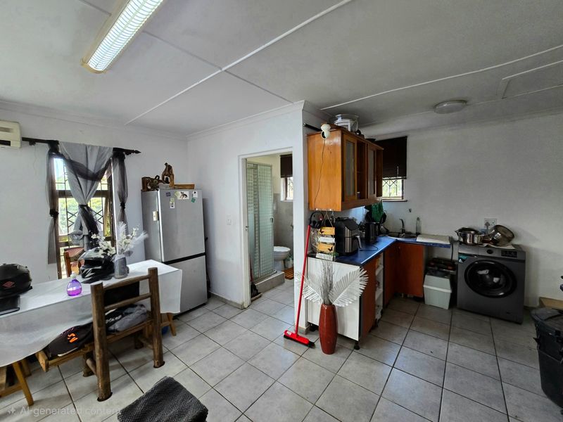 Open plan kitchen and dining area featuring tiled flooring, built-in cabinetry, and direct access to an adjacent bathroom.