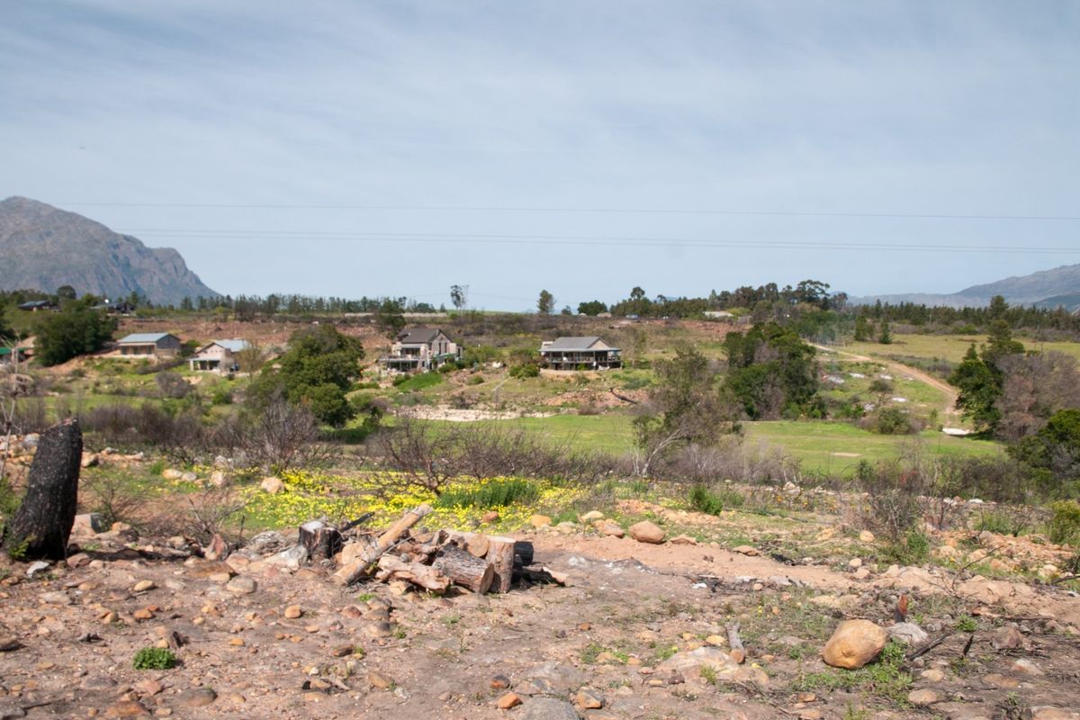 A scenic view of the surrounding landscape, rolling hills, and distant mountain ranges from the vacant residential property.