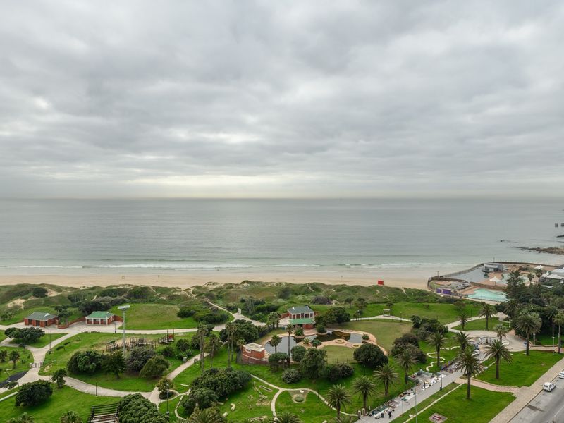 Elevated panoramic view overlooking the coastal park, beach, and ocean, showcasing the property's prime location and scenic surroundings.