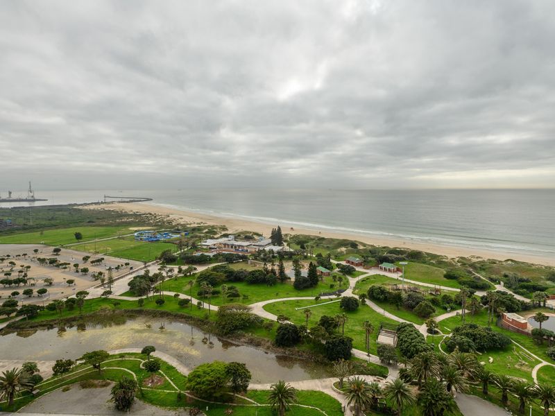 Elevated panoramic view overlooking the coastal park, beach, and ocean horizon.