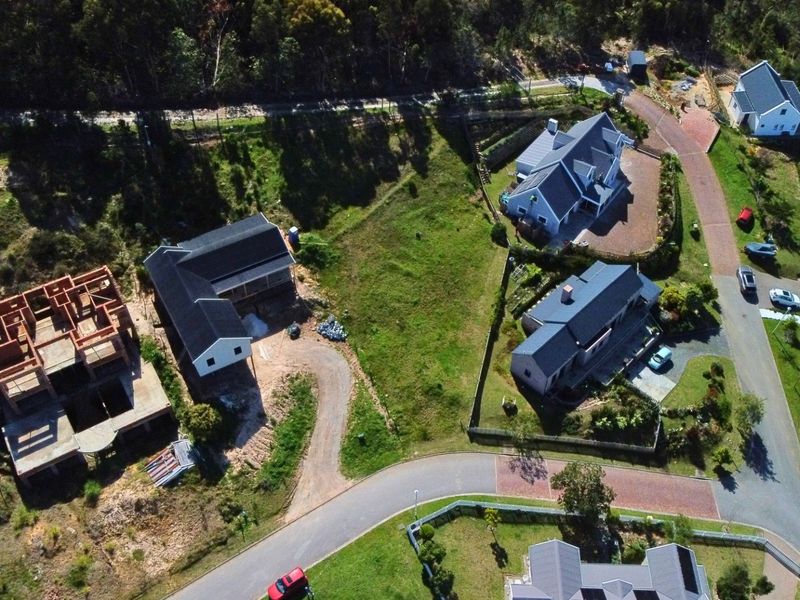 Aerial view of a residential estate featuring established homes and a property currently under construction.
