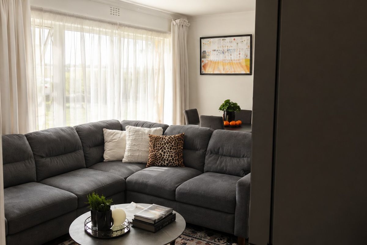 A comfortable living room featuring a large window with natural light, providing a bright and inviting atmosphere for relaxation.