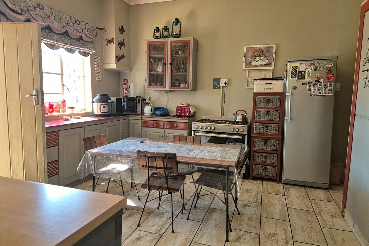 A functional kitchen featuring tiled flooring, fitted cabinetry, and a gas stove, offering a practical layout for daily cooking and dining.