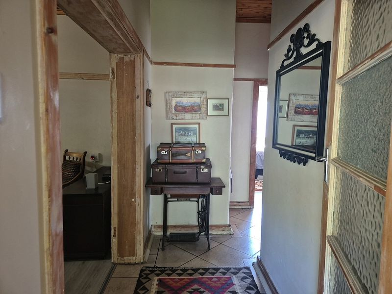 A functional hallway featuring tiled flooring and timber door frames, connecting multiple rooms within the home.