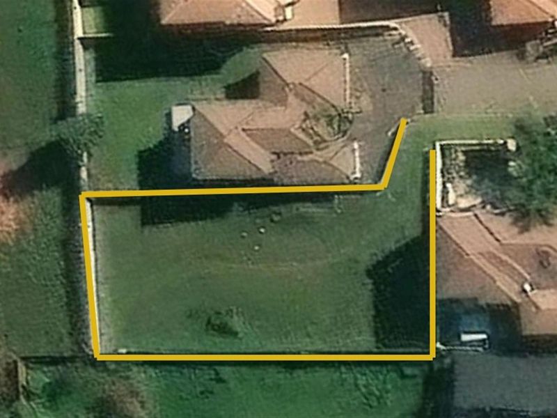 An aerial view of the property showing the building footprint and the demarcated garden area with boundary walls.