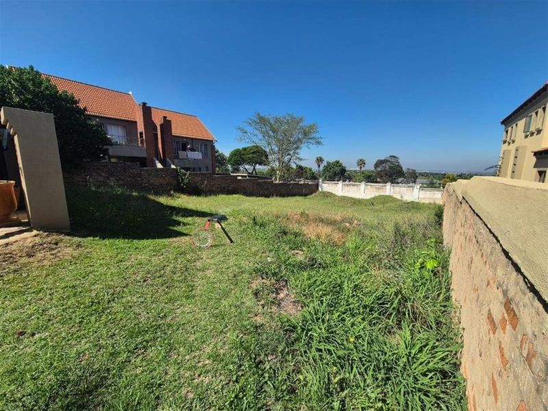A spacious, undeveloped rear garden area enclosed by brick boundary walls, offering potential for landscaping and outdoor living development.