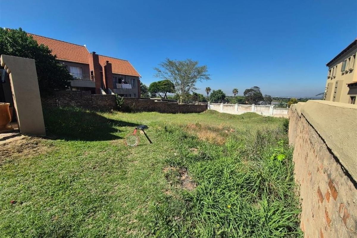 A spacious, undeveloped rear garden area enclosed by brick boundary walls, offering potential for landscaping and outdoor living development.